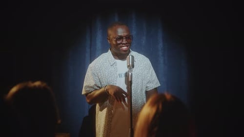 Black Comedian Joking during Live Performance in Stand-Up Club