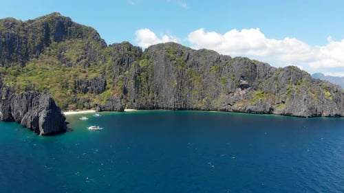Aerial panning view of tropical islands, mountains and emerald sea, El Nido, Palawan, Philippines