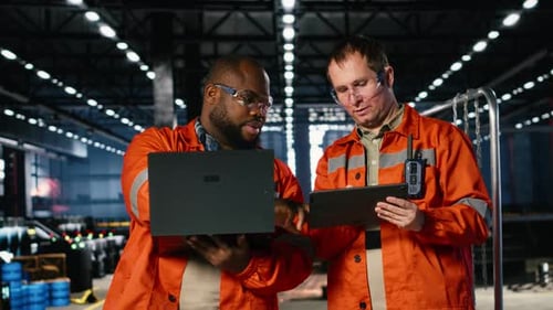 Industrial Staff Oversees Plant Operation with Gadgets Surrounded By Tools