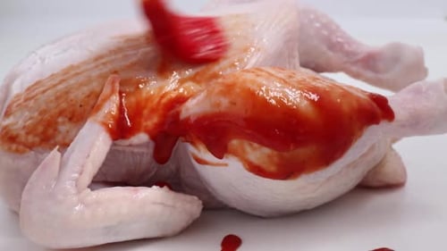 Raw Chicken Brushed With Red Sauce Close Up