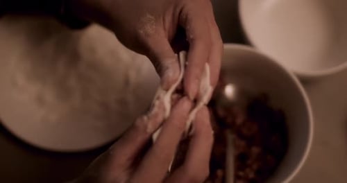Woman making dumplings at home