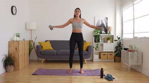 Woman Doing Lateral Raises with Weights at Home