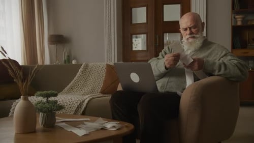 Grandfather in Financial Trouble Looking Through Bills