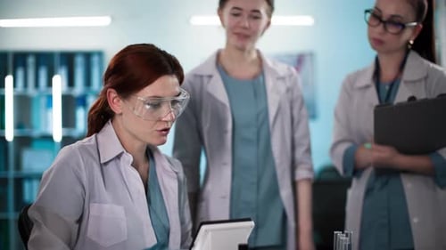 Three Scientists Collaborate on Research in Bright Lab