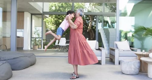 Loving Grandmother Spins Grandchild in Modern Home