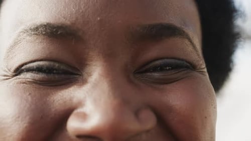 Portrait of happy eyes of african american woman, slow motion