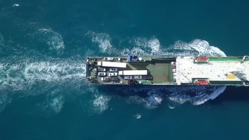 Medium sized Ro-Ro (Roll on/off) ship roaring across The Mediterranean Sea with cars and trucks