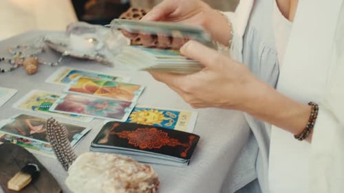 Woman Shuffles Tarot Cards in Spiritual Setting