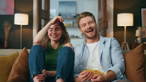 Overjoyed Pair Laughing Comedy Watching Television Indoors Pov. Excited Wife Husband Enjoying