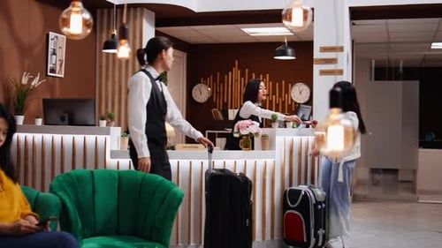 Hotel Receptionists Serve Guest at Modern Hotel Lobby