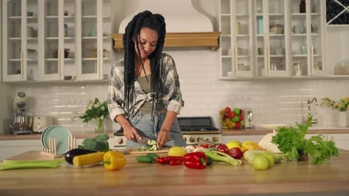 Woman Prepares Colorful Vegetables in Modern Kitchen