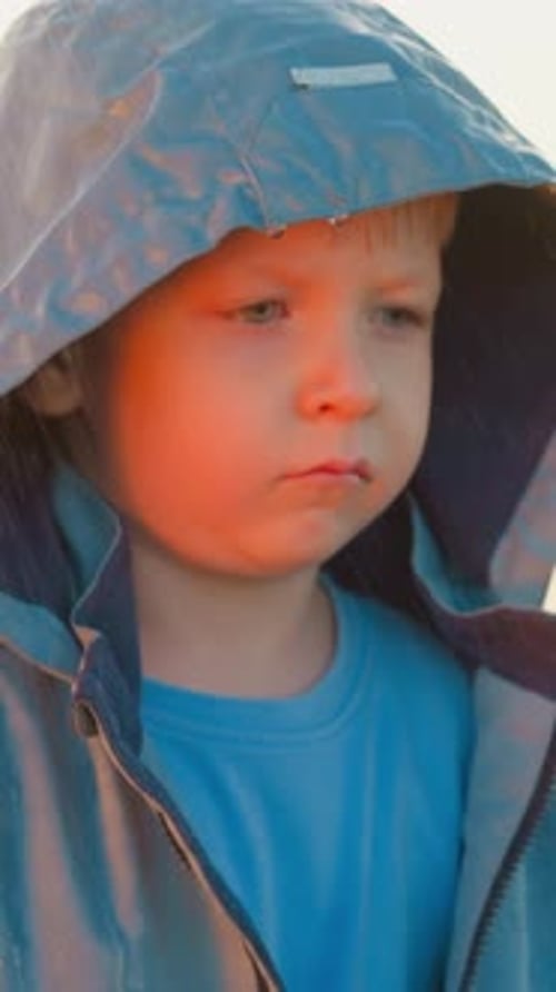 Close Up of Child Wearing Hood in Rain