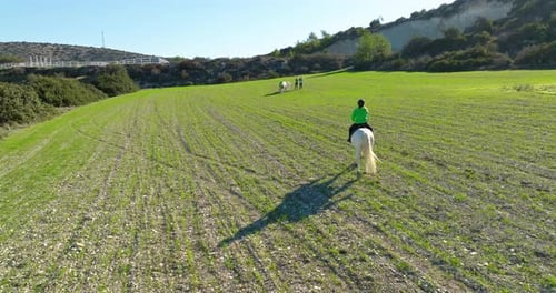 Aerial View Lifestyle of a Woman Riding a Horse on the Field