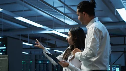 Employee Using Green Screen Devices in Server Farm Used for Automation
