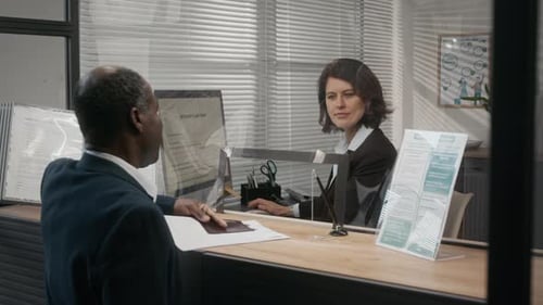 Mature Black Businessman Applying for Visa at Embassy