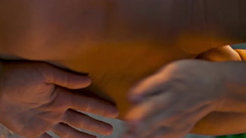 Hands Deeply Massage a Muscular Back