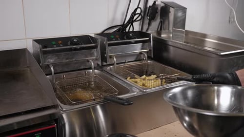 Chef Cooking French Fries He Puts a Grid of Potatoes in Deepfried Boiling Oil