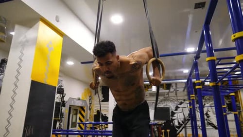 Strong African Athlete Doing Push Ups on Gymnastic Rings at Gym Muscular Afro American Sportsman