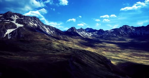 Majestic Mountain Landscape with Sunlight Illuminating Grassy Valleys