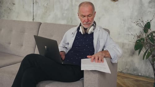 Senior Man Working on Laptop at Home