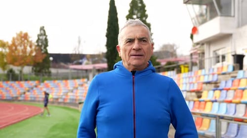 Senior Man Warming Up at Outdoor Stadium