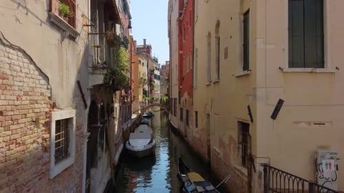 Venetian canal showing a small footbridge and docked boats