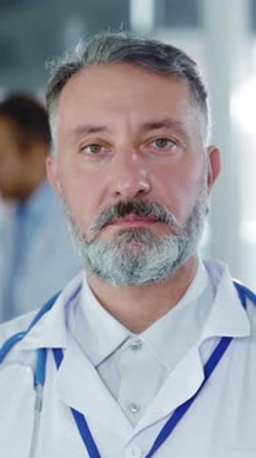 Handsome Mature Caucasian Man Doctor Portrait in Medical Office Face of Professional Chief Therapist