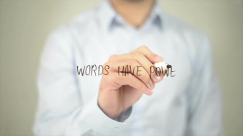 Man Writing Words Have Power on Glass
