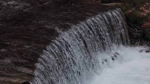 The water flows beautifully over the rocks. Mountain river. Beautiful little waterfalls.