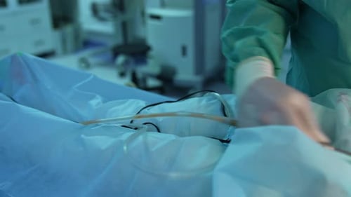 Surgeon pumping fat from patient's body.