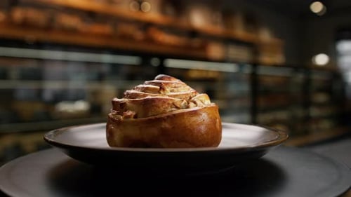 Close-up, bakery - delicious bun with jam on a rotating surface