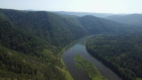 Awesome aerial view of scenic river among evergreen woods