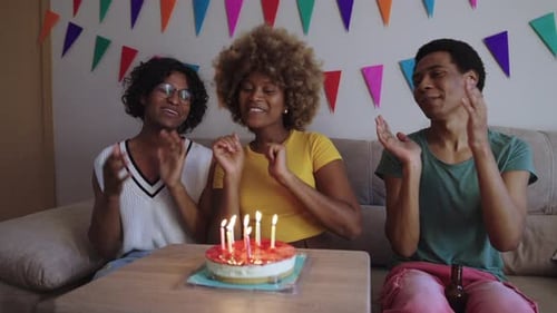 Friends Celebrate Birthday with Cake and Candles