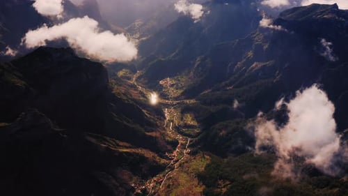 Aerial drone view overlooking a valley between mountains, in Pico Do Arieiro, Madeira