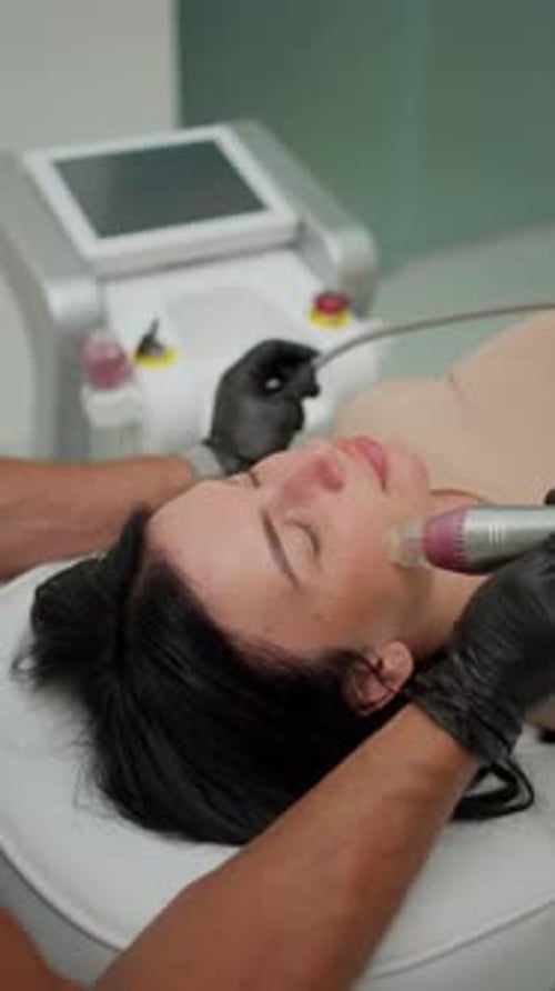 Woman Receiving Facial Treatment in Medical Clinic