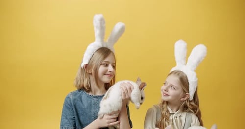 Girls with Bunny Ears Holding Cute Rabbits