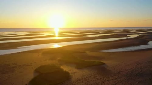 Cape Cod Bay Beach Aerial Drone Footage at Low Tide During Golden Hour, Bright Sun Low and Setting,