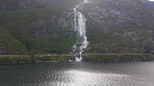 Aerial view of iconic Langfossen waterfall flowing in Norway fjord