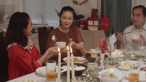 Family Celebrates Christmas Dinner Together at Home