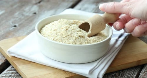 Nutritional Yeast Flakes in a Bowl with Scoop