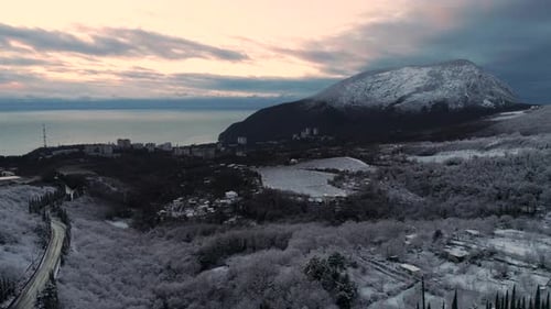 A Serene Snowy Landscape Showcasing a Breathtaking Mountain View During the Dusk Hour