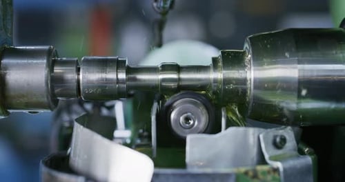Slow motion macro of specialist is working on production of different gearing details in a worksho
