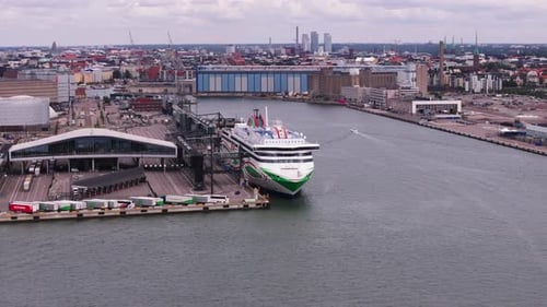 Aerial Shot of Large Cruise Ferry Moored in Harbour Vehicles in Logistic Area Waiting for Loading on