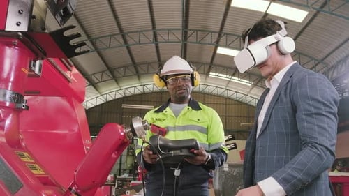 Engineers Operate Robot Arm with Virtual Reality in Factory