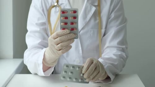 Medical Professional Holding Blister Packs of Medication