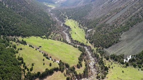 Alamedin Gorge, green valley with river, drone rotation shot