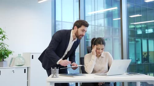 Angry Boss Scolding Employee in a Modern Office