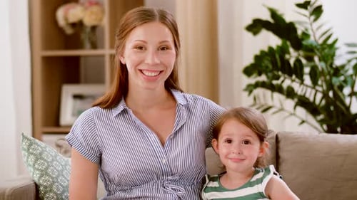 Smiling Mother and Daughter Portrait in Living Room