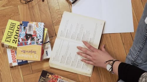 Young Adult Studying With Books at Home