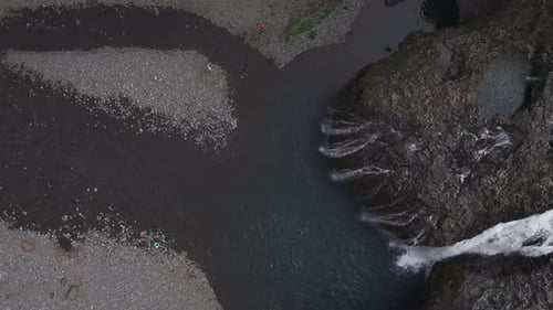 Aerial view of people jumping at Stjornarfoss waterfall, Iceland